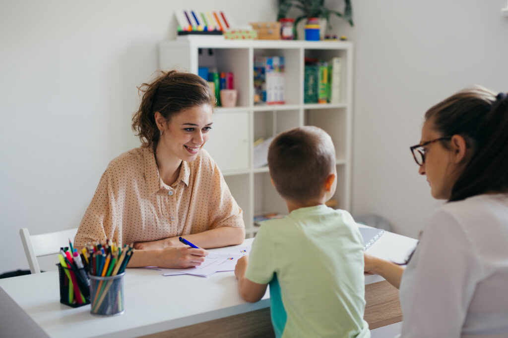 boy having conversation with psychologist for enrollment in school